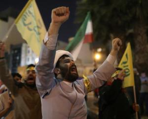 Iranians celebrate on a street in Tehran, after the drone attack on Israel. Photo: Majid...