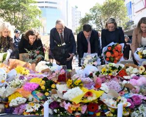 Australian Prime Minister Anthony Albanese lays flowers at the scene of the mass stabbing in...