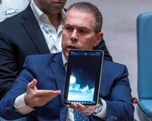 Israel's Ambassador to the United Nations, Gilad Erdan, shows a video of Iranian missile attacks...