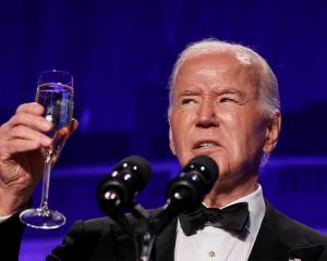 US President Joe Biden raises a toast during the White House Correspondents' Association Dinner...