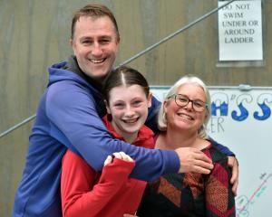 Swimmer Anna Harrex is hugged by her parents Andrew and Christine.