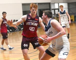 Andy Bay Falcons guard Toby Lewis (right) tries to create space against Mid City Magic defender...