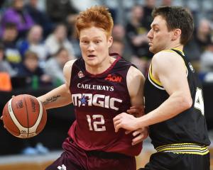 No 12 for the Magic Mitchell Hughan (left) and No 4 for St Kilda James Ross come up against one...