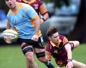 University flanker Oliver Geddes gets past Alhambra-Union defenders (from left) Jordan Gush and...