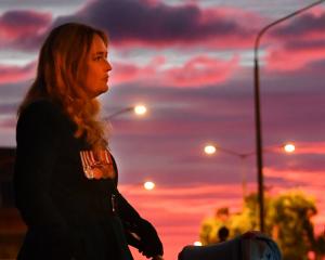 Teddy Baker, 1,  looks up as  LastPost is played at the Anzac dawn service at the cenotaph in...