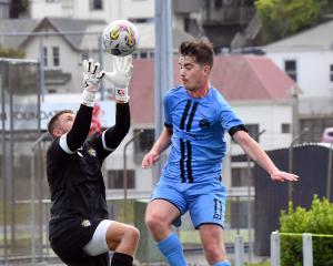 Dunedin City Royals player, Will Turner, engages in an aerial battle with Cashmere keeper Danny...