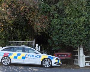 Police outside an overgrown property in Garfield Ave, Roslyn yesterday where a body was located....