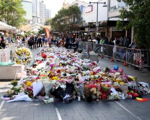 Flowers lie outside Sydney's Westfield Shopping mall in honour of the victims of the stabbing...