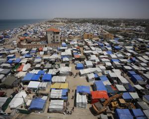 Thousands of Palestinians have begun to flee Rafah, many setting up makeshift tent camps in the...