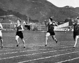 H.D. Morgan (left) wins the 100 yards race for Otago at the Easter inter-varsity tournament. —...