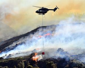 Helicopters with monsoon buckets were called in to fight a vegetation fire at Lee Stream, near...