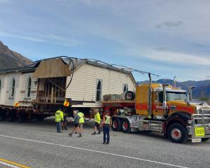 King House Removals staff wait on the side of the road near Queenstown to let traffic past late...