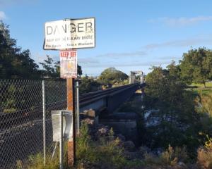 Danger signs at the rail bridge at Ngāruawāhia. Photo: RNZ 