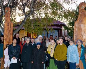 The Te Whare Koa Marae community gathers beside the newly installed pou on Saturday morning in...