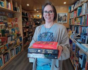 Wānaka bookseller Sarah Clark, holding some of her favourite reads, is excited to win a...