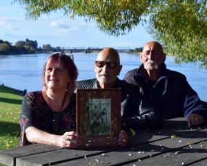 Showing a photo of their ancestor, chief Haimona Rakiraki Waitaha Kaitahu, are (from left) iwi...