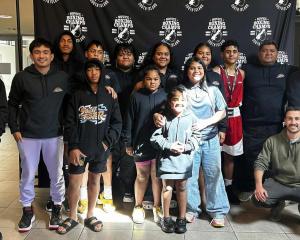 Boxers and members of the Taafaki Boxing Club celebrate together after a strong showing at the...