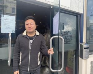 Canjoy Cantonese Cuisine co-owner Ricky Cheng is preparing to open for business at lunchtime...