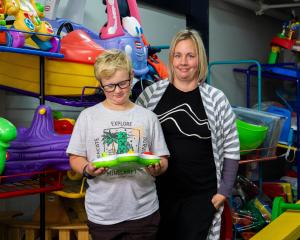 Alex Henderson checks out one of the toys alongside North Otago Toy Library president Sarah...