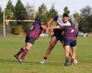 West Taieri enforcer Ethan Hippolite runs into some heavy contact from Clutha Valley defenders...