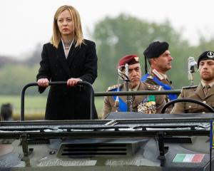  Italy's Prime Minister Giorgia Meloni reviews an honour guard. PHOTO: REUTERS