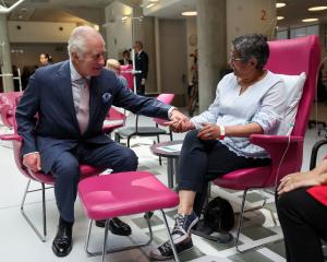 King Charles talks with patient Asha Millan during a visit to the University College Hospital...