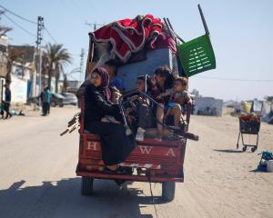 Palestinians flee Rafah after Israeli forces launched a ground and air operation in the eastern...
