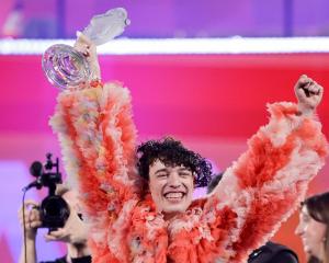 Switzerland's Nemo appears on stage after winning during the Grand Final of the 2024 Eurovision...