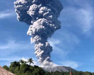A column of ash rises over the Mount Ibu volcano, in Tabaru, North Maluku province on Monday....