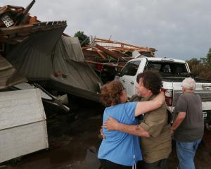 June Handsaker consoles her brother Larry Handsaker after a tornado damaged his house in the town...