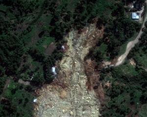 A satellite image shows buried homes after the landslide in Yambali village. Photo: Maxar...