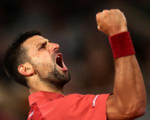Defending champion Novak Djokovic celebrates getting through to round two at Roland Garros. Photo...
