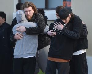 Young people support each other at the Dunedin bus hub yesterday, as a large group gathered for a...