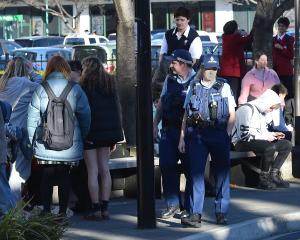 Police patrol through the Bus Hub in Great King St yesterday afternoon. Photo: Gregor Richardson
