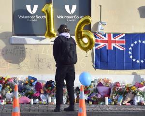 Flowers lie where Enere McLaren-Taana was fatally stabbed at the Dunedin bus hub. PHOTO: PETER...