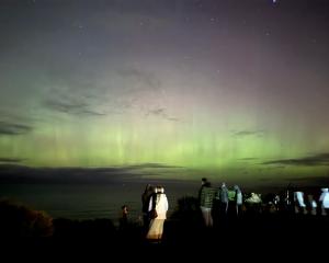 People watch the aurora over the south coast from St Clair, near Cargill’s Castle, about 9.30pm...