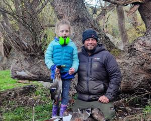 Bella Murray 7, of Lawrence, harvests wild tucker with her dad Paul Murray on opening day of the...