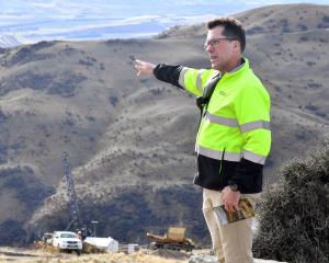 Santana Minerals Ltd chief executive Damian Spring motions towards the Central Otago landscape...