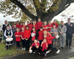 East Gore School pupils and staff stand in front of Rākanui, a tree planted by former headmaster...