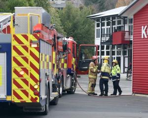 Fire and Emergency NZ personnel at the scene in North Dunedin. Photo: Peter McIntosh