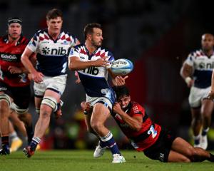 Harry Plummer of the Blues looks to pass during a Super Rugby Pacific game against the Crusaders...