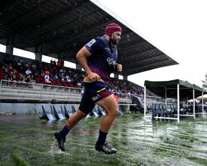 Highlanders captain Billy Harmon runs on to the field during his team’s round 11 Super Rugby...