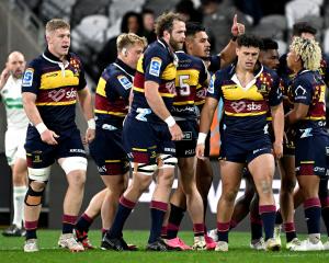 The Highlanders celebrate after midfielder Tanielu Tele’a scored the opening try against the...