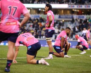 Rebels players react during their round 14 Super Rugby Pacific match against the Brumbies in...