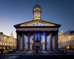 The Gallery of Modern Art in Glasgow with the statue of the Duke of Wellington crowned with his...