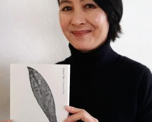 Grace Yee with her poetry collection, Chinese Fish. Photo: Instagram @graceyeepoet