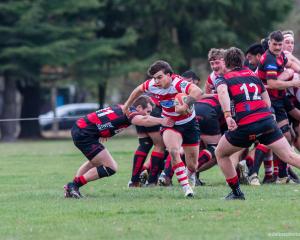 Burnside halfback and co-captain Joel Lam tries to break a tackle during his side’s 45-7 win over...