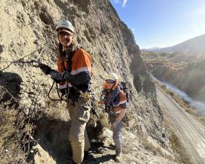 Working on Nevis Bluff, above State Highway 6, earlier this week are Roman Alty (left) and Liam...