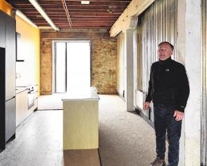Property developer Russell Lund stands in one of the "five-star" social housing units in his...