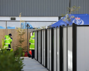 Police set up a specialist search group tent in the yard of a Christchurch apartment. Photo: RNZ 